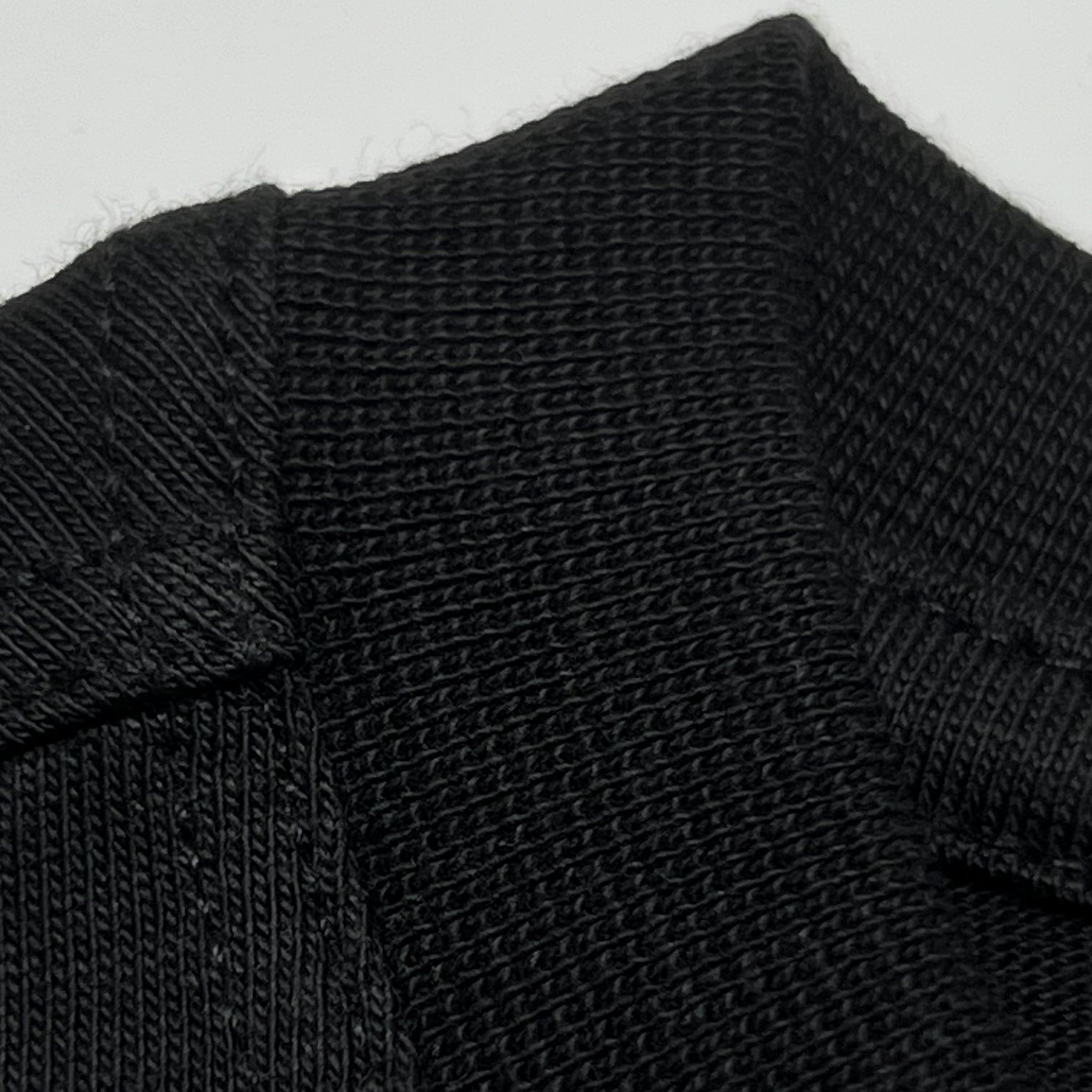 Angled view of front collar and stitching on black King Cyrus SUPIMA® cotton t-shirt