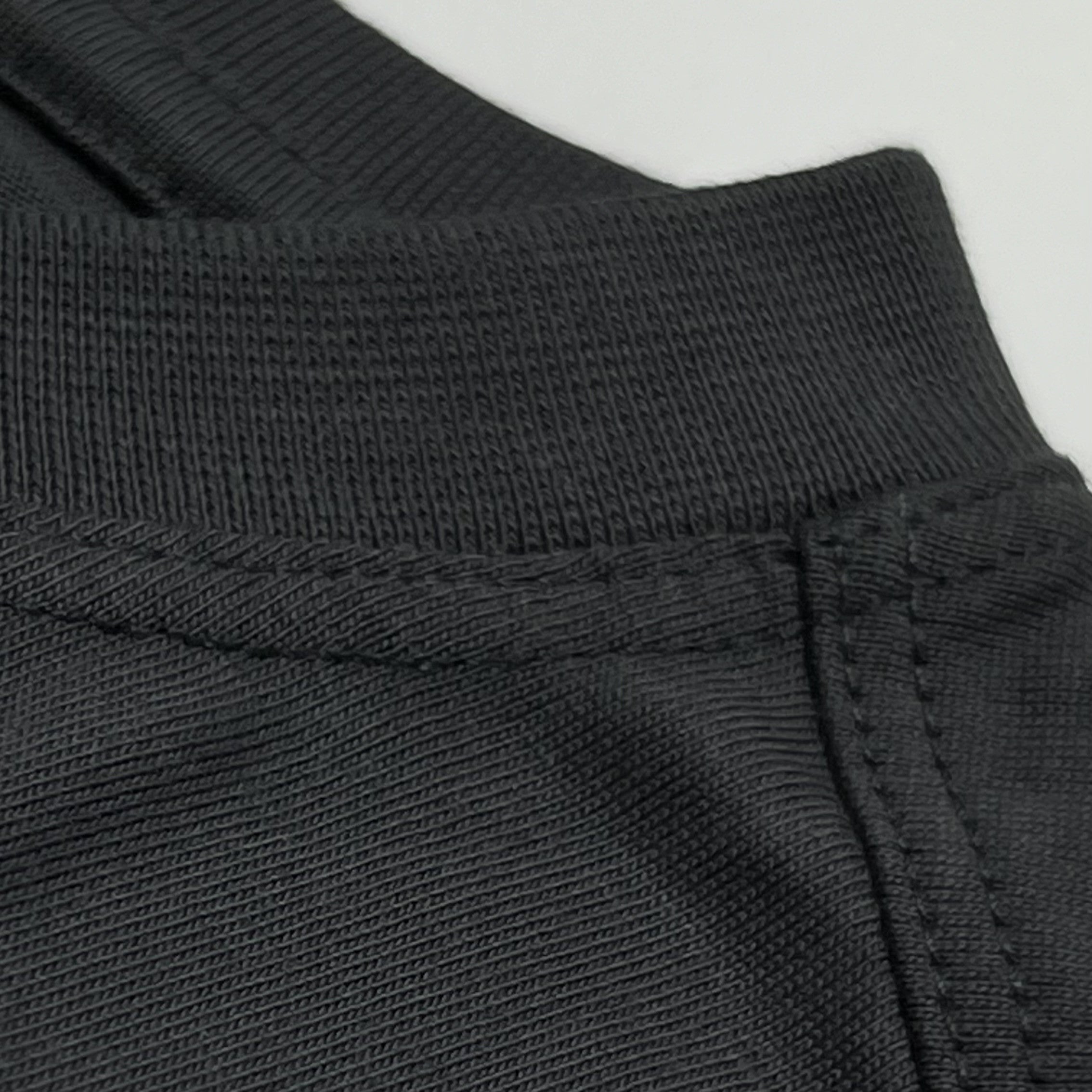 Close-up of front collar seam and ribbed neckline on black SUPIMA® cotton King Cyrus t-shirt