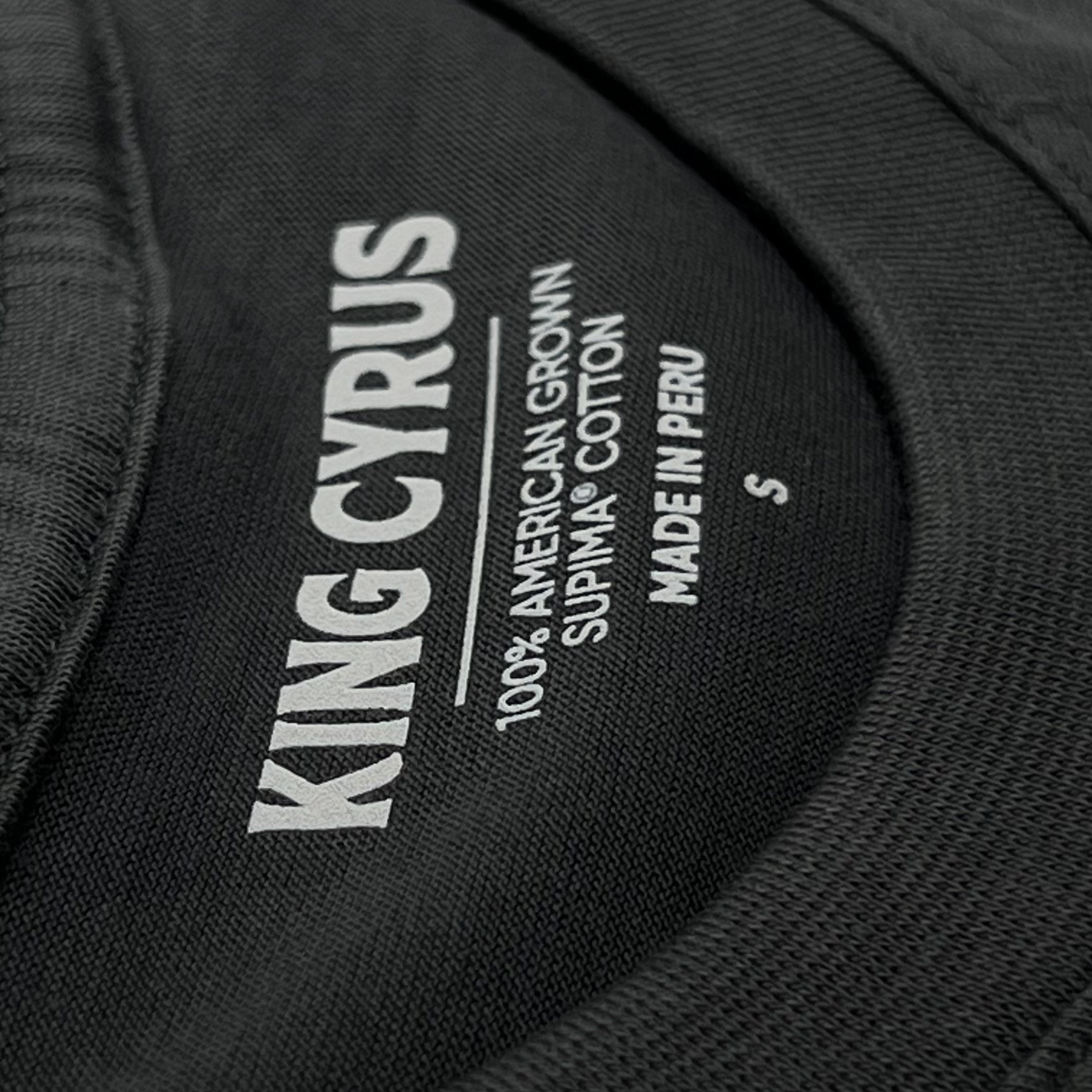 Interior neck label with King Cyrus branding on black SUPIMA® cotton t-shirt