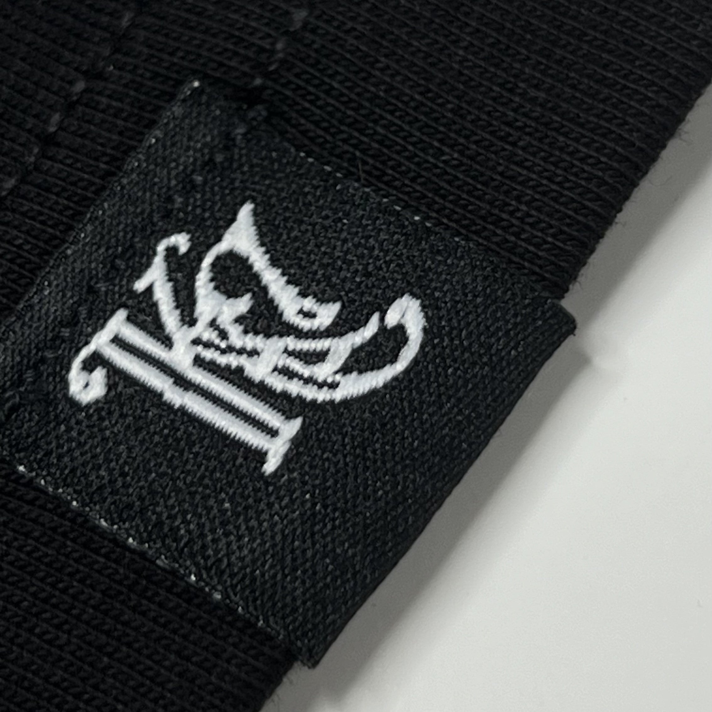 Woven KC monogram label on sleeve of black King Cyrus t-shirt