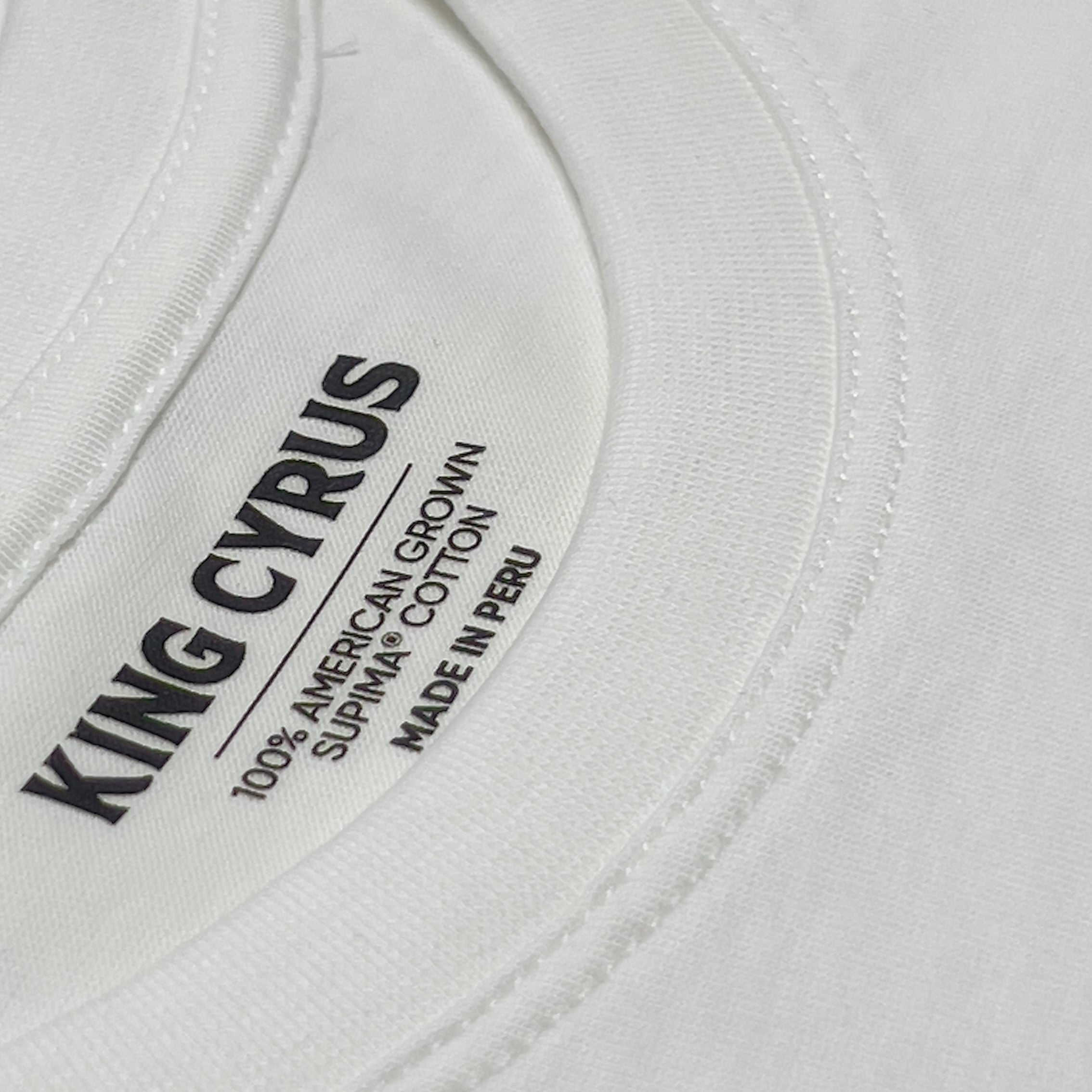 Interior neck label with King Cyrus branding on white SUPIMA® cotton t-shirt